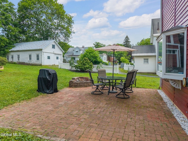 138 Elm St, Cobleskill, NY 12043 - view of patio / terrace with a fire pit, a grill, an outbuilding, and outdoor dining space