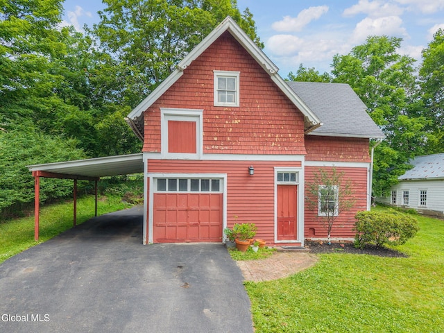 138 Elm St, Cobleskill, NY 12043 - view of front of house featuring driveway, a front lawn, and a garage