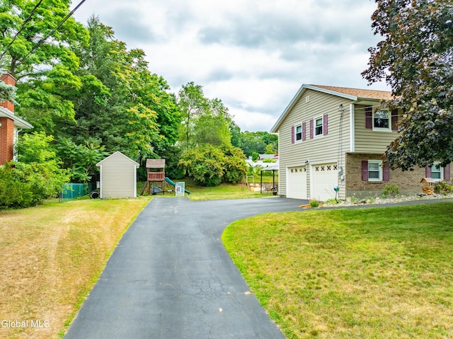10 Tower Hts, Colonie, NY 12211 - view of home's exterior with an attached garage, asphalt driveway, and a playground