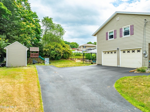 10 Tower Hts, Colonie, NY 12211 - view of side of property with driveway, a yard, an attached garage, and a playground