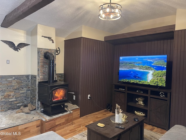 12 Louden Rd, Saratoga Springs, NY 12866 - living area featuring light wood-type flooring, a textured ceiling, wainscoting, a wood stove, and vaulted ceiling
