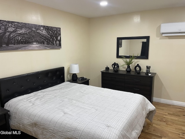 12 Louden Rd, Saratoga Springs, NY 12866 - bedroom with an AC wall unit, wood finished floors, and recessed lighting