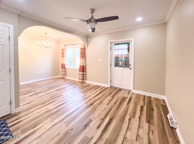 4 Hillside Ave, Schenectady, NY 12308 - empty room featuring arched walkways, wood finished floors, a chandelier, a ceiling fan, and ornamental molding
