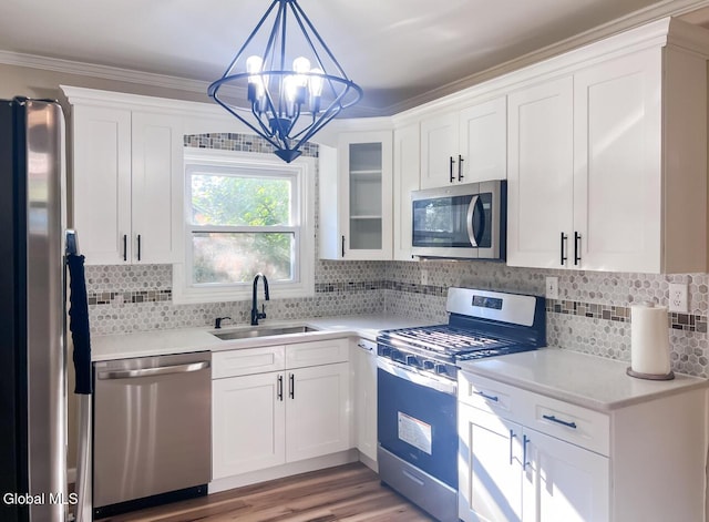 4 Hillside Ave, Schenectady, NY 12308 - kitchen with appliances with stainless steel finishes, light countertops, white cabinets, pendant lighting, and ornamental molding