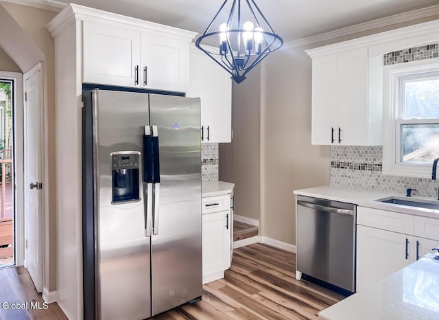 4 Hillside Ave, Schenectady, NY 12308 - kitchen featuring stainless steel appliances, light countertops, backsplash, light wood finished floors, and white cabinets