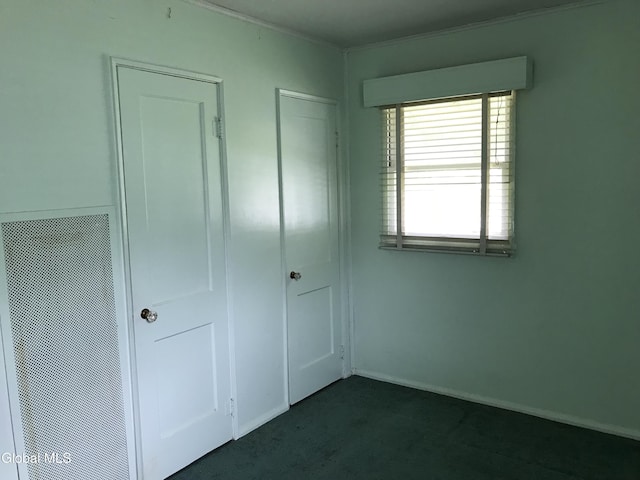 23 Cottage Hill Rd, Queensbury, NY 12804 - unfurnished bedroom with dark colored carpet, a closet, and crown molding