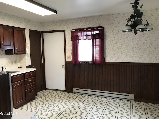 23 Cottage Hill Rd, Queensbury, NY 12804 - kitchen with a baseboard radiator, wainscoting, wallpapered walls, light countertops, and dark brown cabinetry