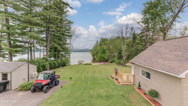 115 Shore Dr, Broadalbin, NY 12025 - view of green lawn with an outbuilding and a deck with water view