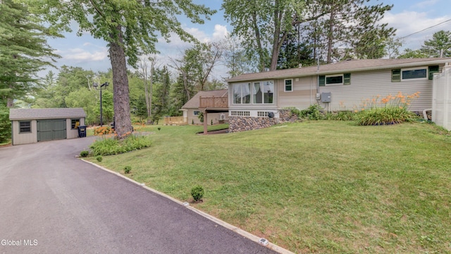 115 Shore Dr, Broadalbin, NY 12025 - view of front facade featuring an outdoor structure, a front yard, and driveway