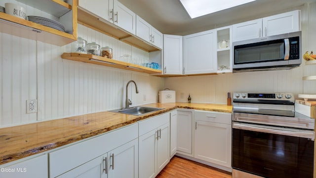 115 Shore Dr, Broadalbin, NY 12025 - kitchen featuring open shelves, appliances with stainless steel finishes, white cabinetry, and light wood-style floors