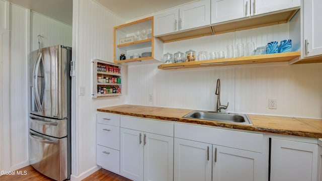 115 Shore Dr, Broadalbin, NY 12025 - kitchen with freestanding refrigerator, open shelves, wood finished floors, and white cabinetry