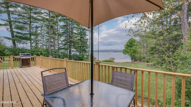115 Shore Dr, Broadalbin, NY 12025 - wooden deck featuring outdoor dining area, a water view, area for grilling, a yard, and view of scattered trees