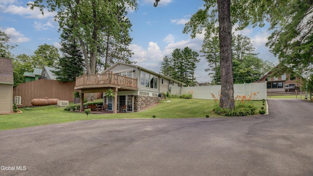115 Shore Dr, Broadalbin, NY 12025 - view of front of property featuring a wooden deck, stone siding, and a patio area