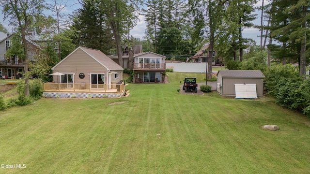115 Shore Dr, Broadalbin, NY 12025 - view of green lawn featuring a wooden deck and a storage shed