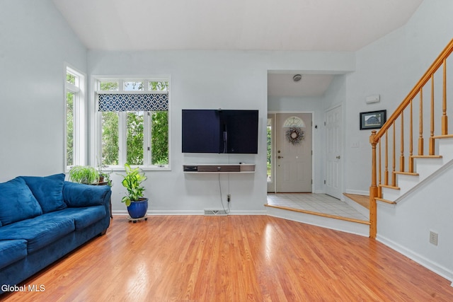 5 Gregg Rd, Altamont, NY 12009 - unfurnished living room featuring wood finished floors, stairs, and healthy amount of natural light