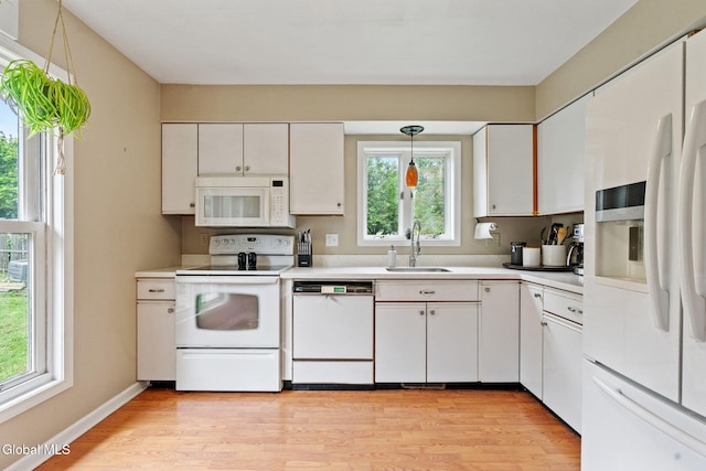 5 Gregg Rd, Altamont, NY 12009 - kitchen with white appliances, light wood finished floors, light countertops, and healthy amount of natural light