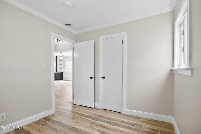 789 Troy Schenectady Rd, Colonie, NY 12110 - unfurnished bedroom featuring ornamental molding and light wood-style floors