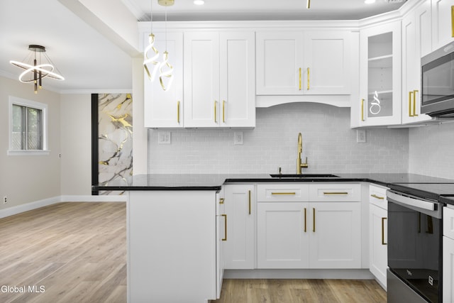 789 Troy Schenectady Rd, Colonie, NY 12110 - kitchen featuring stainless steel appliances, crown molding, white cabinets, decorative backsplash, and dark countertops