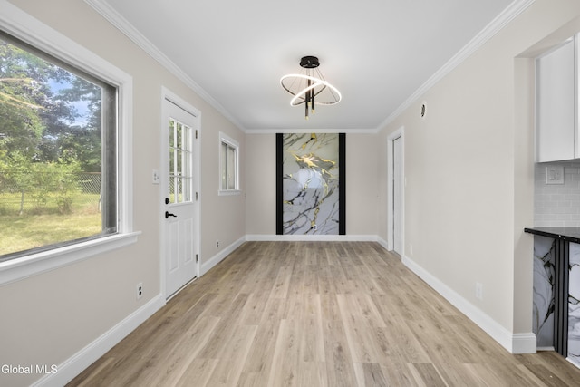 789 Troy Schenectady Rd, Colonie, NY 12110 - unfurnished dining area featuring light wood-type flooring, a chandelier, and crown molding