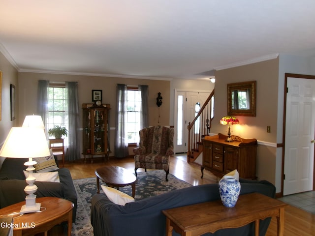 22 Frances Ln, Bethlehem, NY 12203 - living area featuring light wood-style floors, ornamental molding, and stairway