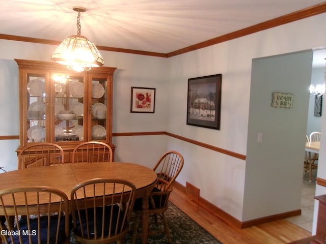 22 Frances Ln, Bethlehem, NY 12203 - dining space with a chandelier, wood finished floors, and crown molding