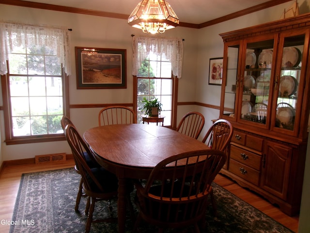 22 Frances Ln, Bethlehem, NY 12203 - dining area featuring light wood-style flooring, a chandelier, and crown molding
