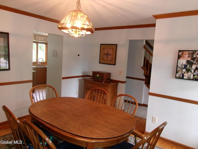 22 Frances Ln, Bethlehem, NY 12203 - dining room with a chandelier, ornamental molding, and wood finished floors