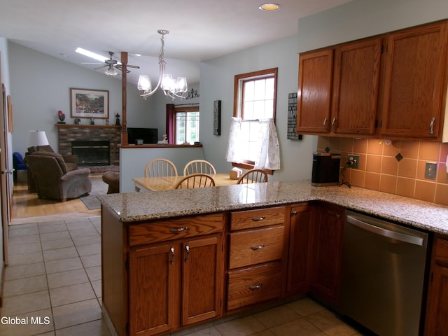 22 Frances Ln, Bethlehem, NY 12203 - kitchen with stainless steel dishwasher, a peninsula, light tile patterned floors, brown cabinetry, and recessed lighting