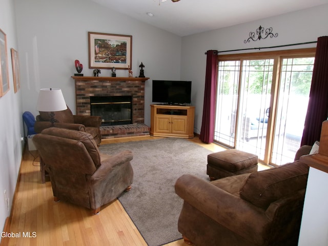 22 Frances Ln, Bethlehem, NY 12203 - living room featuring light wood-type flooring, vaulted ceiling, and a brick fireplace