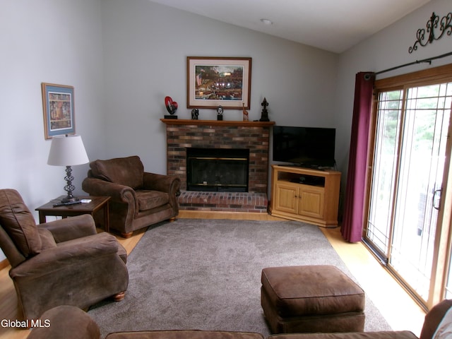 22 Frances Ln, Bethlehem, NY 12203 - living room featuring lofted ceiling, a brick fireplace, and light wood-style floors
