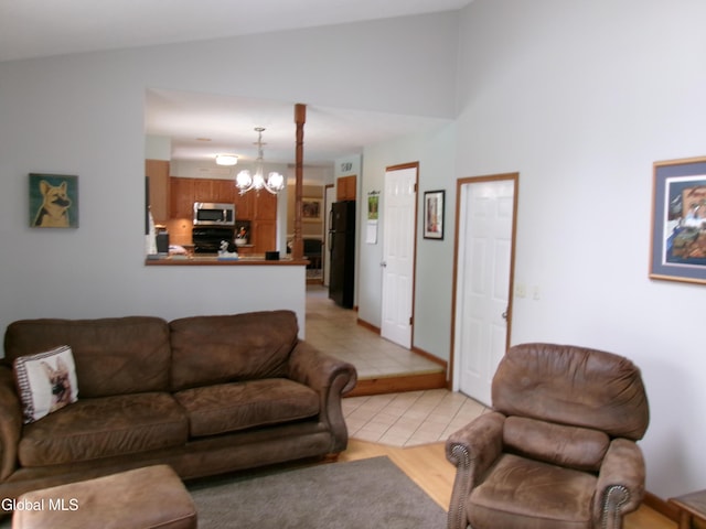 22 Frances Ln, Bethlehem, NY 12203 - living room with a chandelier, light tile patterned floors, and vaulted ceiling