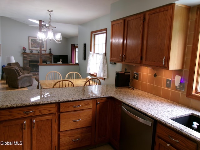 22 Frances Ln, Bethlehem, NY 12203 - kitchen featuring stainless steel dishwasher, brown cabinets, decorative backsplash, and pendant lighting