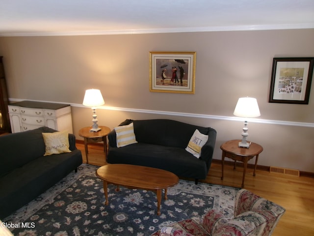 22 Frances Ln, Bethlehem, NY 12203 - living area featuring wood finished floors and crown molding