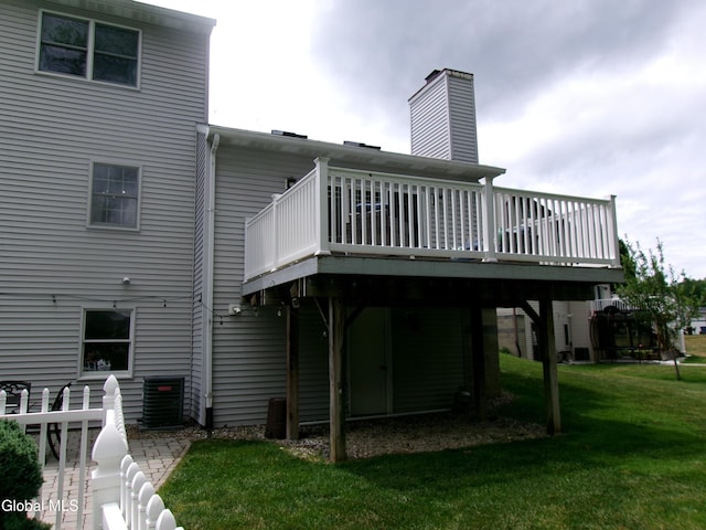 22 Frances Ln, Bethlehem, NY 12203 - back of property featuring a deck, a yard, and a chimney
