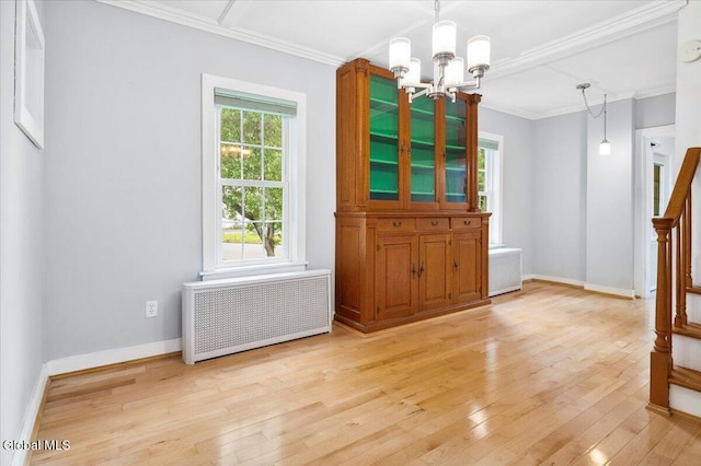 7 Swan St, Hudson Falls, NY 12839 - unfurnished dining area featuring radiator, a chandelier, light wood finished floors, and crown molding