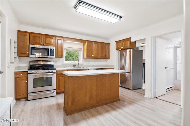 7 Swan St, Hudson Falls, NY 12839 - kitchen featuring stainless steel appliances, light countertops, light wood-style floors, brown cabinets, and a baseboard radiator