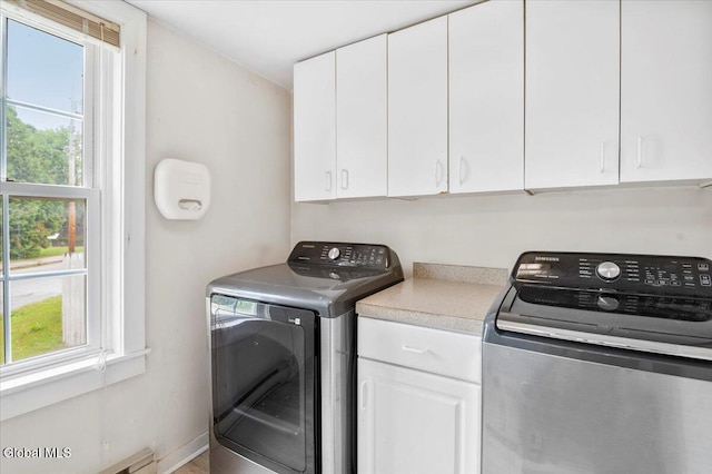7 Swan St, Hudson Falls, NY 12839 - laundry room featuring healthy amount of natural light, cabinet space, a baseboard heating unit, and washer and clothes dryer