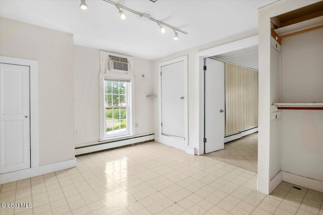 7 Swan St, Hudson Falls, NY 12839 - unfurnished room with a baseboard heating unit, rail lighting, and a wall mounted air conditioner