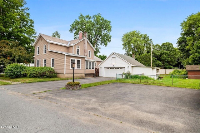 7 Swan St, Hudson Falls, NY 12839 - view of front of house with an outbuilding, a chimney, and a detached garage