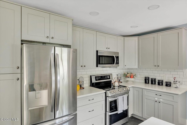 611 Via Ponderosa, Schenectady, NY 12303 - kitchen featuring stainless steel appliances, light countertops, and backsplash