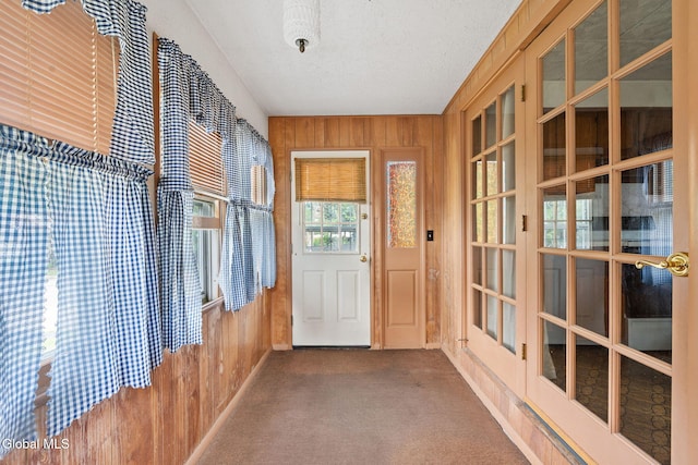 2780 Campbell Ave, Schenectady, NY 12306 - entryway with wooden walls, carpet flooring, and a textured ceiling