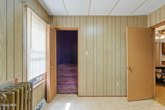 2780 Campbell Ave, Schenectady, NY 12306 - unfurnished bedroom featuring radiator and wood walls
