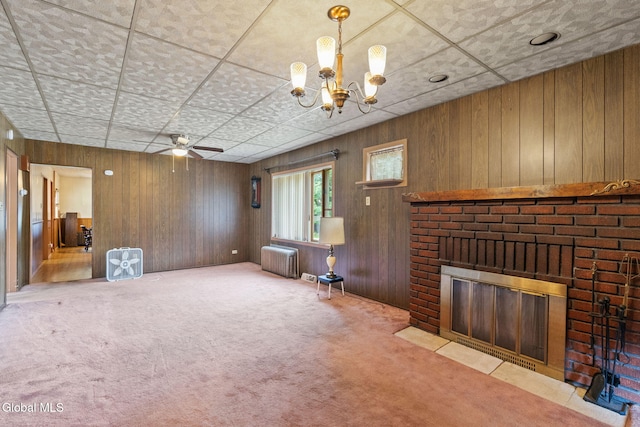 2780 Campbell Ave, Schenectady, NY 12306 - unfurnished living room with radiator, a fireplace, a chandelier, carpet flooring, and wood walls