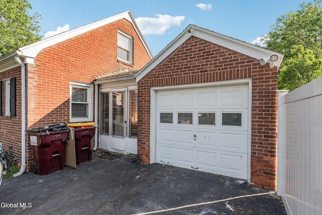 19 Elmhurst Ave, Colonie, NY 12205 - view of front of house featuring brick siding, a garage, and asphalt driveway