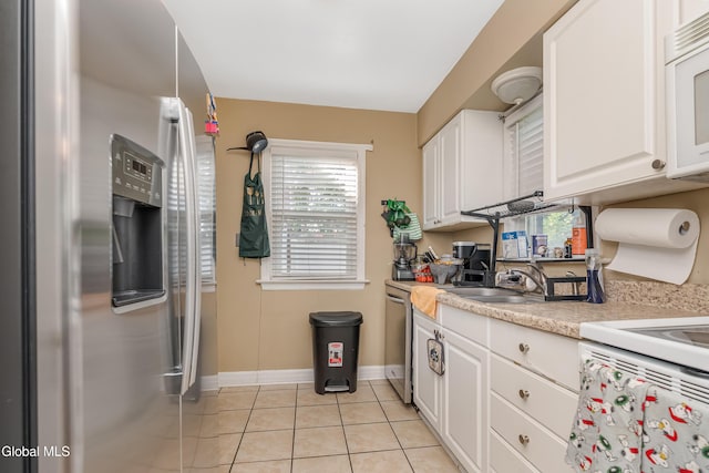 19 Elmhurst Ave, Colonie, NY 12205 - kitchen with appliances with stainless steel finishes, light tile patterned floors, light countertops, and white cabinetry