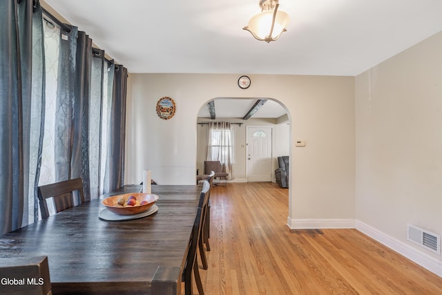 19 Elmhurst Ave, Colonie, NY 12205 - dining room with arched walkways and light wood-style floors