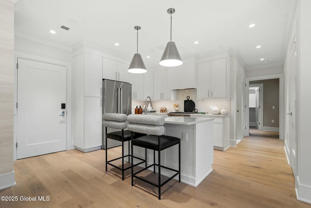 19 Washington St Unit 552P, Saratoga Springs, Inside, NY 12866 - kitchen with high end fridge, crown molding, light countertops, a kitchen breakfast bar, and light wood finished floors