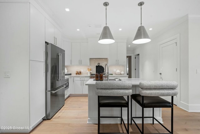 19 Washington St Unit 552P, Saratoga Springs, Inside, NY 12866 - kitchen with freestanding refrigerator, light countertops, white cabinetry, tasteful backsplash, and ornamental molding