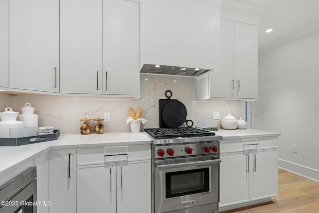 19 Washington St Unit 552P, Saratoga Springs, Inside, NY 12866 - kitchen with premium stove, white cabinets, decorative backsplash, light countertops, and light wood-type flooring