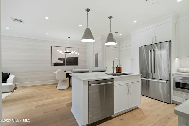 19 Washington St Unit 552P, Saratoga Springs, Inside, NY 12866 - kitchen with appliances with stainless steel finishes, white cabinetry, light wood-style floors, light countertops, and wallpapered walls